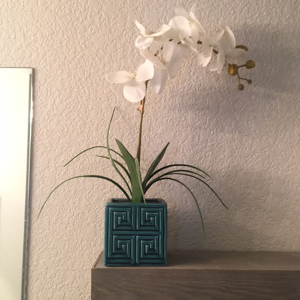 Faux white orchid in blue pot